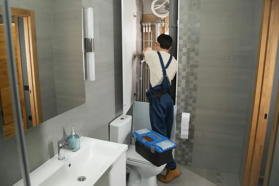 Plumber repairing a bathroom fixture