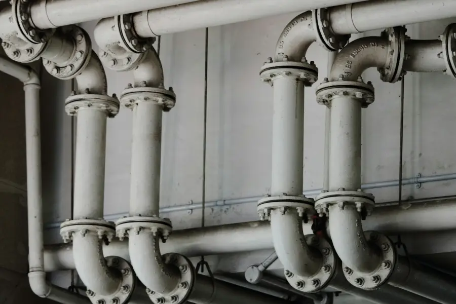 Metal drain pipes running along a wall