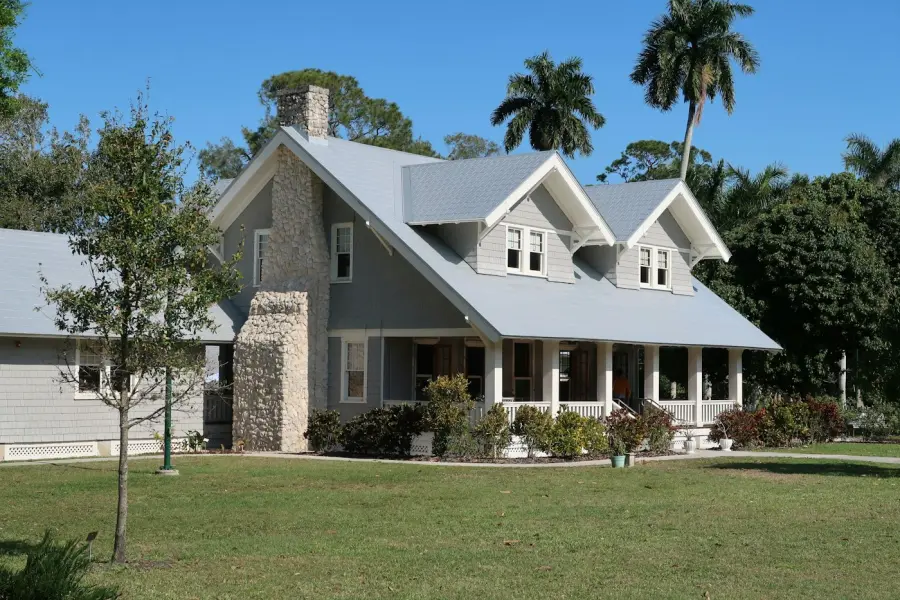 Gray house with chimney and covered front porch